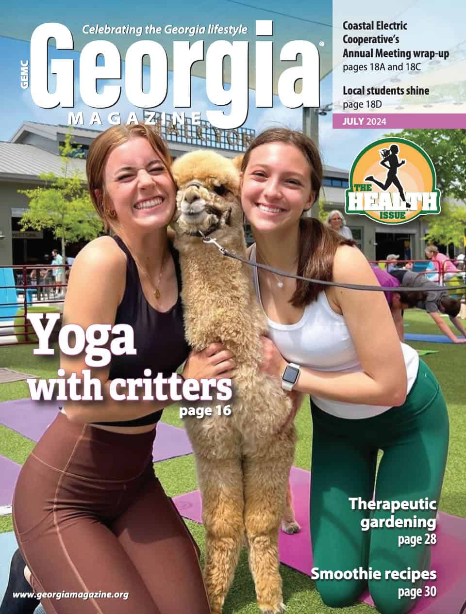 July 2024 Georgia Magazine cover features two female yoga participants enjoying a snuggle with Coco the alpaca during a Farm Animal Yoga on the green event.