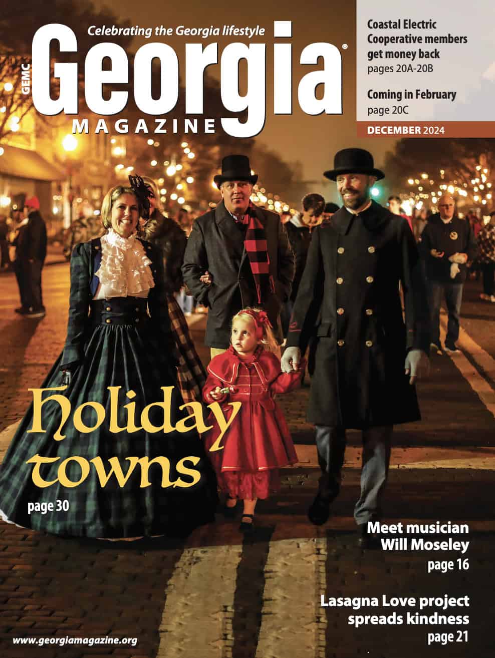 People in vintage attire stroll down a festive, illuminated street in Georgia. Magazine cover highlights holiday towns, musician Will Moseley, and a kindness project.