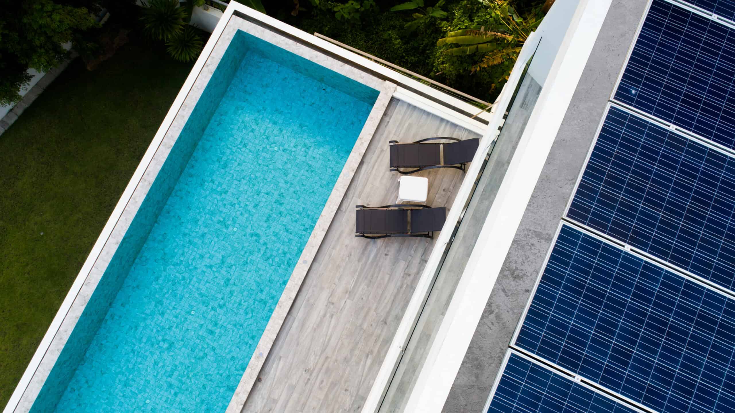 Aerial view of swimming pool and solar panels