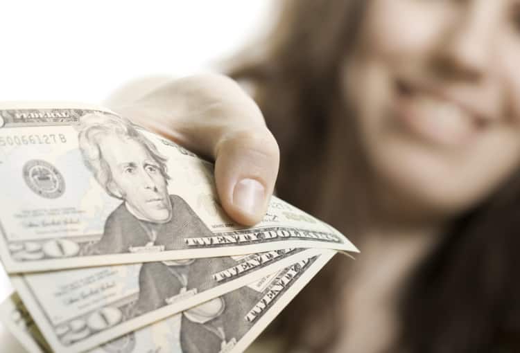 Smiling woman with cash in-hand