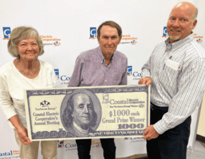 Member appreciation winner Charles Tilton poses with his check