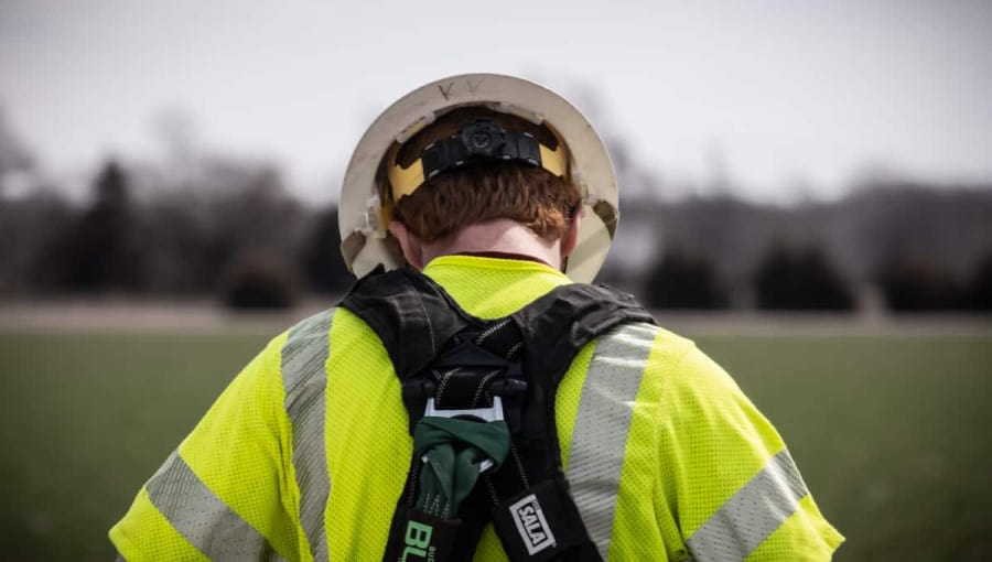 A linemen is seen from behind.