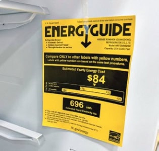 An "EnergyGuide" label on an appliance displays estimated annual energy cost of $84 and usage of 696 kWh, advising comparison with similar labels.