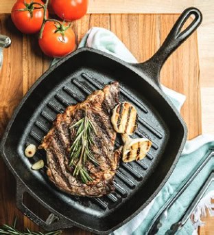 A griddle pan is pictured with a beautiful steak