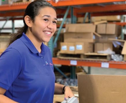 Young woman smiles as she works her summer job