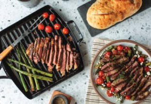 Steak and asparagus are presented on a griddle pan