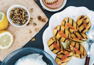 Grilled Peaches are displayed on a plate