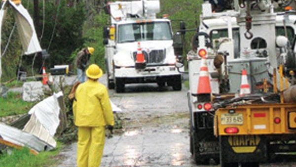 Linemen are pictured starting work on downed lines.