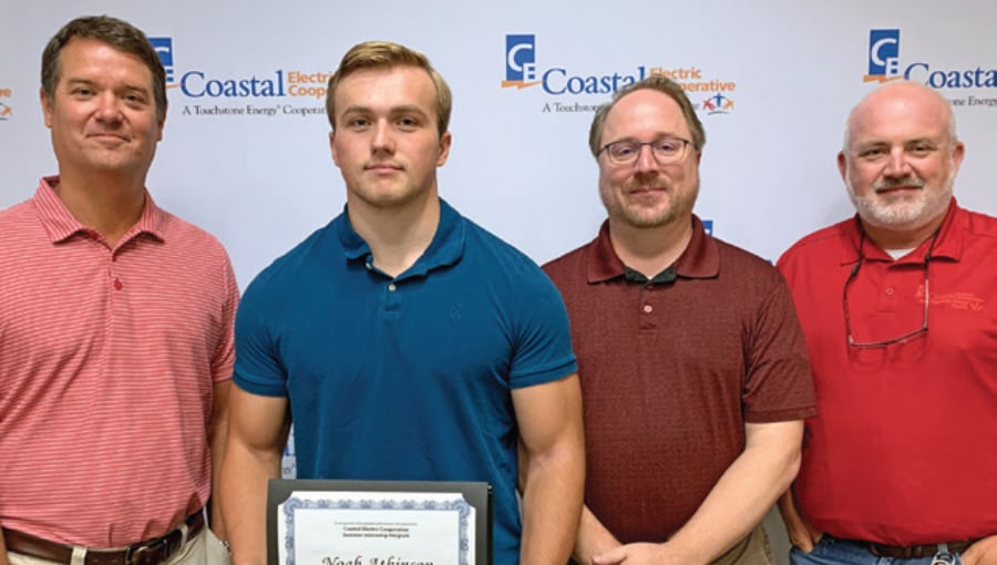 A summer learning student is pictured with cooperative staff